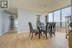 Dining area featuring light wood-type flooring and baseboards - 