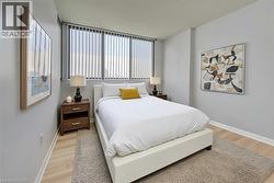 Bedroom featuring a textured ceiling and light wood-type flooring Virtually Staged - 