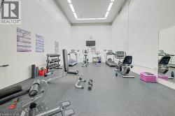 Exercise room featuring a towering ceiling - 