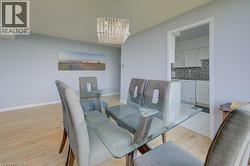 Dining room featuring light wood-style floors and a chandelier - 