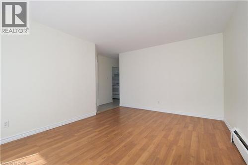 Spare room featuring a baseboard heating unit and light wood-style floors - 24 Austin Drive, Waterloo, ON - Indoor Photo Showing Other Room