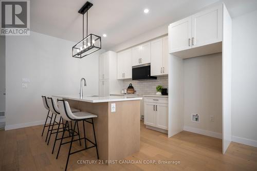 Tiled Backsplash and OTR Microwave Combo Added - 4297 Calhoun Way, London South (South V), ON - Indoor Photo Showing Kitchen With Upgraded Kitchen