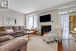 Living room with gas fireplace, access to backyard - 