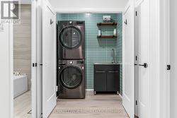 Gorgeous laundry closet with stainless steel sink - 