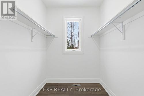 Primary bedroom walk-in closet w/ window - 49 Beaufort Crescent, Tiny, ON - Indoor With Storage