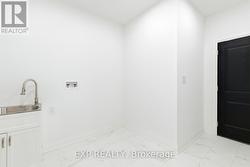 Mudroom w/ combo laundry room, access to garage - 