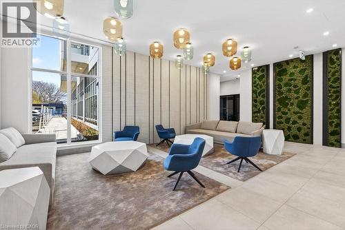 Lounge area featuring floor-to-ceiling windows, sculptural pendant lighting, textured wall panels, and preserved moss art installations - 500 Plains Road E Unit# 207, Burlington, ON - Indoor