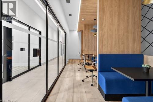 Modern hallway featuring a full-height glass partition with black framing - 500 Plains Road E Unit# 207, Burlington, ON - Indoor Photo Showing Other Room