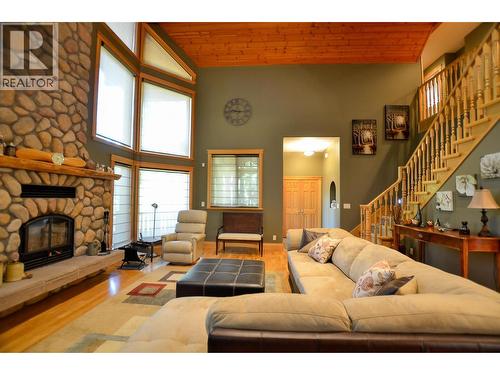 Cosy up in front of the fireplace with blinds up or down. - 19-3453 Cessna Road, Enderby, BC - Indoor Photo Showing Living Room With Fireplace