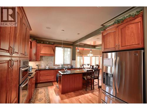 Efficient and beautiful with a view of the stone fireplace, what more could you ask for in a kitchen? - 19-3453 Cessna Road, Enderby, BC - Indoor Photo Showing Kitchen With Double Sink