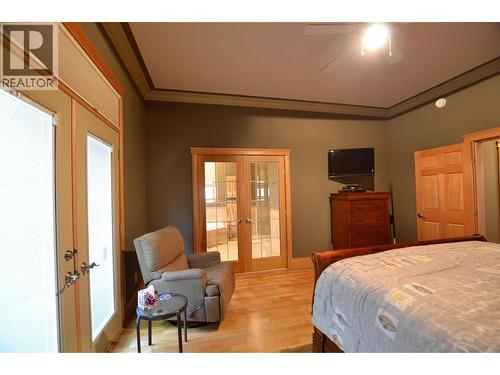 French doors to the ensuite add a spa like touch to the primary main floor bedroom. - 19-3453 Cessna Road, Enderby, BC - Indoor Photo Showing Bedroom