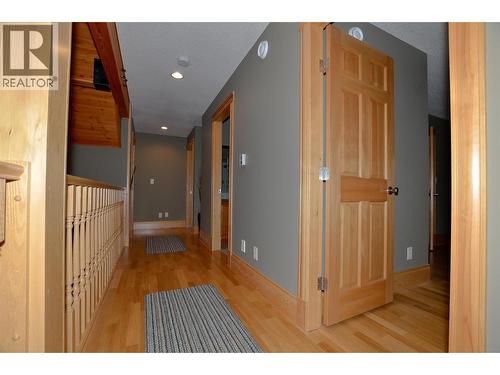 Veranda walkway overlooks the fireplace - 19-3453 Cessna Road, Enderby, BC - Indoor Photo Showing Other Room