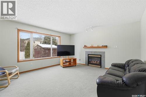 3232 Thames Crescent E, Regina, SK - Indoor Photo Showing Living Room With Fireplace