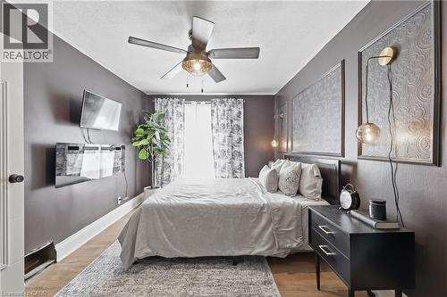 Bedroom featuring wood-finish flooring and a ceiling fan with integrated lighting - 361 Cumberland Avenue, Hamilton, ON - Indoor Photo Showing Bedroom