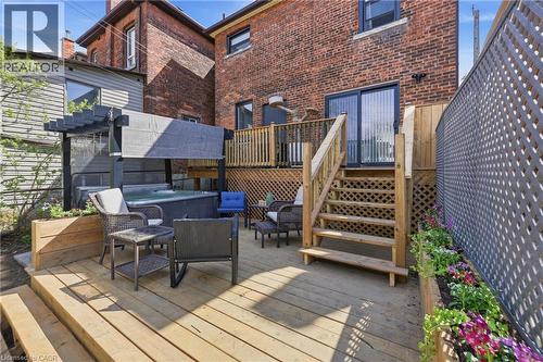 Multi-level deck featuring a hot tub with a pergola, built-in planters, and a lattice privacy fence - 361 Cumberland Avenue, Hamilton, ON - Outdoor With Deck Patio Veranda With Exterior