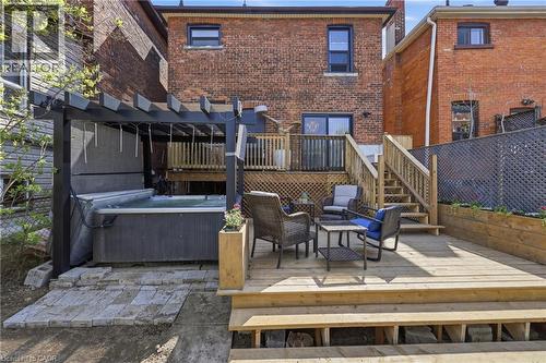 Multi-level wooden deck featuring a built-in hot tub with a pergola, integrated planters, and wooden privacy screening - 361 Cumberland Avenue, Hamilton, ON - Outdoor With Deck Patio Veranda With Exterior
