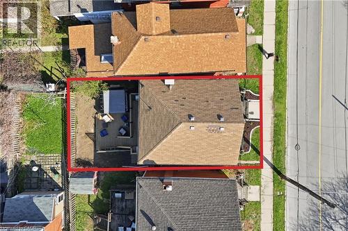 Property features a private backyard deck, a fenced perimeter, and a detached shed - 361 Cumberland Avenue, Hamilton, ON - Outdoor With Exterior