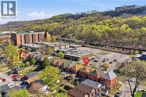 Aerial view showcasing a residential neighborhood with brick homes, featuring mature trees and established landscaping - 361 Cumberland Avenue, Hamilton, ON - Outdoor With View