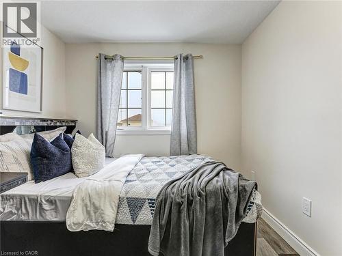 Bedroom featuring a grid-pattern window, light wood-finish flooring, and light-toned wall paint - 154 Deerpath Drive, Guelph, ON - Indoor Photo Showing Bedroom