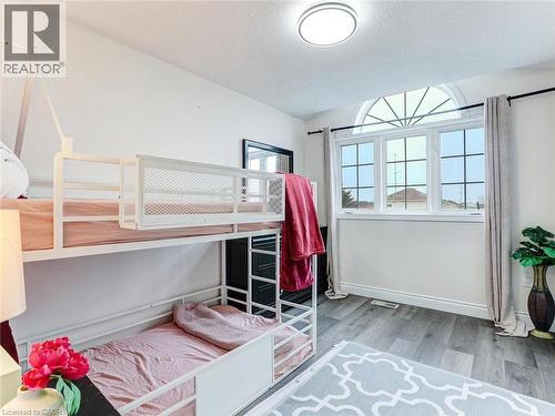 Room featuring light wood-finish flooring and a contemporary overhead light fixture - 154 Deerpath Drive, Guelph, ON - Indoor