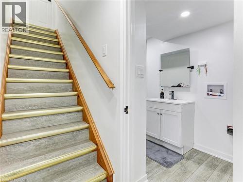 Staircase with wood-finish treads and risers, featuring a coordinating wood handrail - 154 Deerpath Drive, Guelph, ON - Indoor Photo Showing Other Room