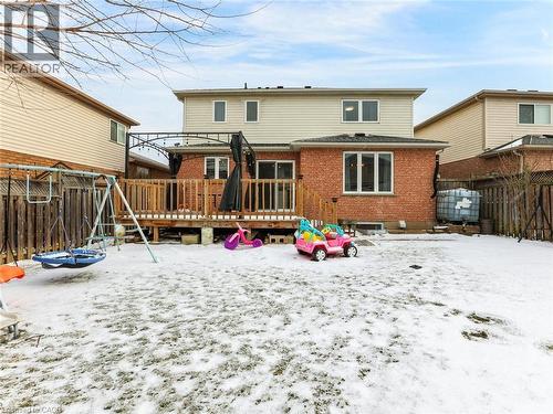 Rear exterior featuring a brick first level, siding second level, and a wooden deck with railing - 154 Deerpath Drive, Guelph, ON - Outdoor With Deck Patio Veranda
