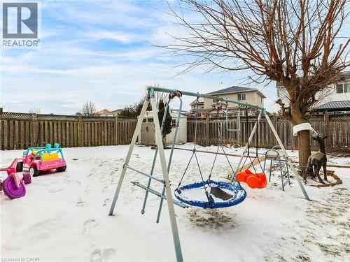 Fenced backyard featuring mature tree and storage shed - 154 Deerpath Drive, Guelph, ON - Outdoor