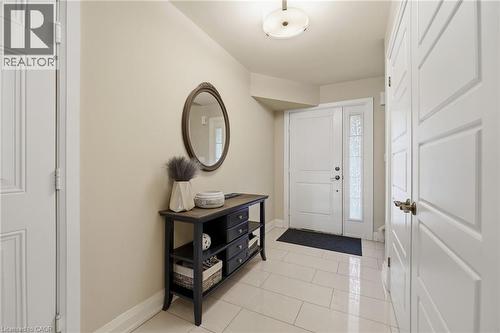 Entryway featuring a white paneled door with sidelight, overhead flush-mount lighting, and light-toned tile flooring - 7 Gibson Place Unit# 26, St. Catharines, ON - Indoor Photo Showing Other Room