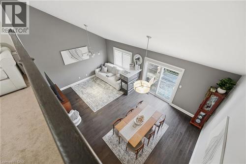 Vaulted ceiling with modern chandelier and pendant lighting fixtures - 7 Gibson Place Unit# 26, St. Catharines, ON - Indoor Photo Showing Other Room
