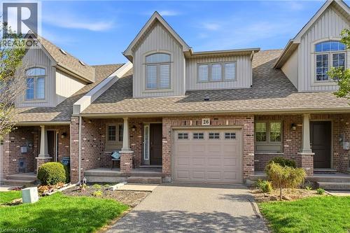 Contemporary multi-level townhome featuring a brick facade with light-colored siding accents and a pitched shingle roof - 7 Gibson Place Unit# 26, St. Catharines, ON - Outdoor With Facade