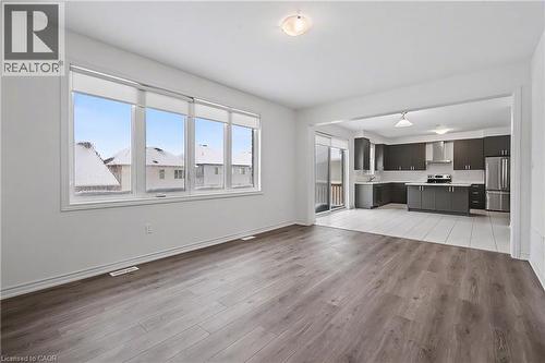 Open-concept living space with wood-finish flooring extending into a modern kitchen - 123 Rea Drive, Fergus, ON - Indoor