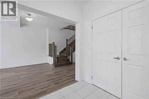 Entryway featuring white six-panel doors with chrome hardware, white floor tile, and a chandelier - 123 Rea Drive, Fergus, ON - Indoor Photo Showing Other Room