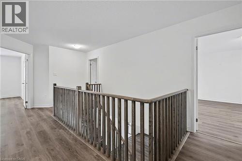 Upper-level landing featuring wood-finish flooring, a wood balustrade, and recessed lighting - 123 Rea Drive, Fergus, ON - Indoor Photo Showing Other Room