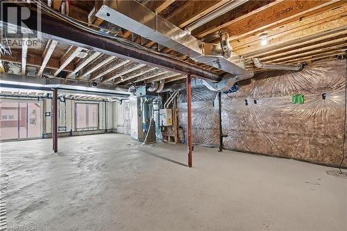 Unfinished basement featuring exposed wood ceiling joists, concrete flooring, and visible ductwork - 123 Rea Drive, Fergus, ON - Indoor Photo Showing Basement