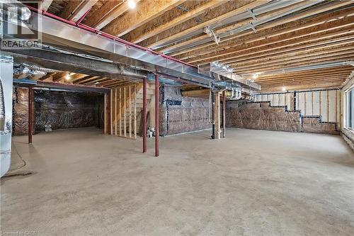 Spacious unfinished basement featuring concrete flooring, exposed ceiling joists, support beams, and visible insulation - 123 Rea Drive, Fergus, ON - Indoor Photo Showing Basement
