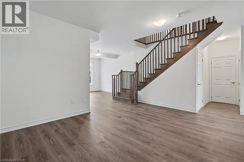 Open-concept living area featuring wood-finish flooring and white baseboards - 123 Rea Drive, Fergus, ON - Indoor Photo Showing Other Room