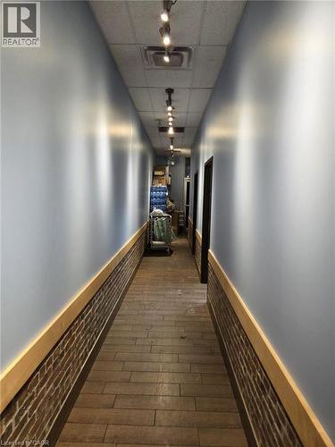 Hallway featuring wood-finish flooring and track lighting - 4322 Ontario Street Unit# 1, Lincoln, ON 