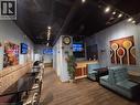 Spacious commercial interior featuring wood-finish flooring and track lighting - 4322 Ontario Street Unit# 1, Lincoln, ON 