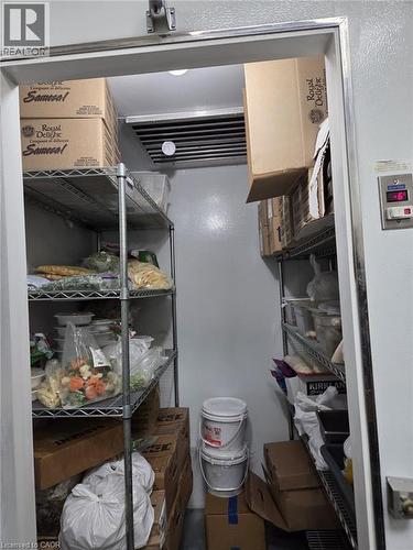 Walk-in refrigeration unit with metal shelving, overhead cooling unit, and digital temperature display - 4322 Ontario Street Unit# 1, Lincoln, ON 