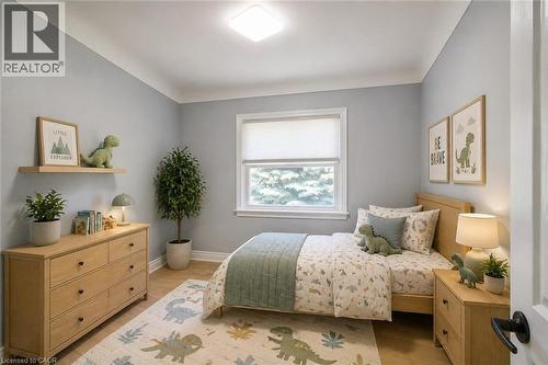 Well-lit room featuring light wood-finish flooring and a single window with a white frame - 31 Brodick Street, Hamilton, ON - Indoor Photo Showing Bedroom