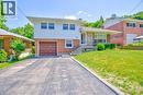 Split-level residence featuring a brick and white siding exterior, an integrated single-car garage, a paved driveway, and a front porch with stone accents - 31 Brodick Street, Hamilton, ON  - Outdoor 