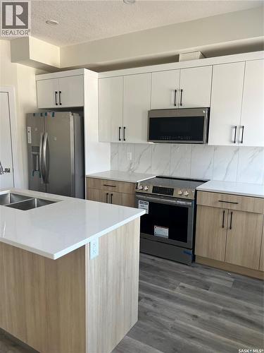 4513 Green Brooks Way E, Regina, SK - Indoor Photo Showing Kitchen With Double Sink