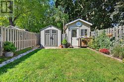 Includes Two Charming Garden Sheds - 