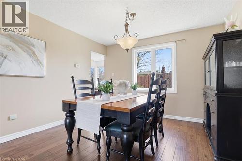 Dining area with wood-finish flooring, neutral wall paint, and white baseboards - 113 Glenecho Court, Waterloo, ON - Indoor Photo Showing Dining Room