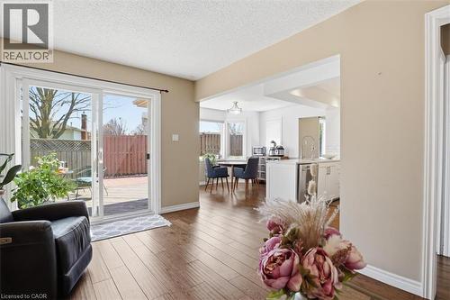 Sliding glass doors opening to an exterior wood-finish deck with privacy fencing - 113 Glenecho Court, Waterloo, ON - Indoor Photo Showing Other Room