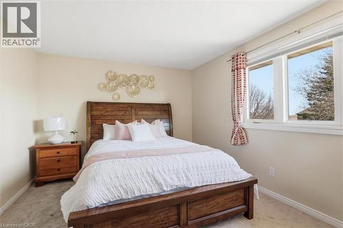 Bedroom featuring a large window, neutral wall paint, and light-toned carpeting - 113 Glenecho Court, Waterloo, ON - Indoor Photo Showing Bedroom