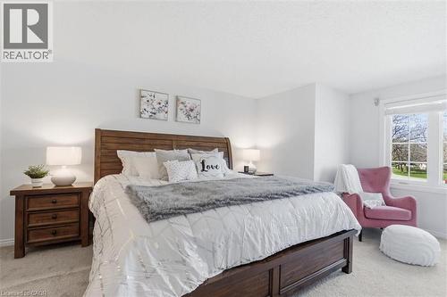 Bedroom featuring a large window, light-toned carpeting, and white walls - 113 Glenecho Court, Waterloo, ON - Indoor Photo Showing Bedroom