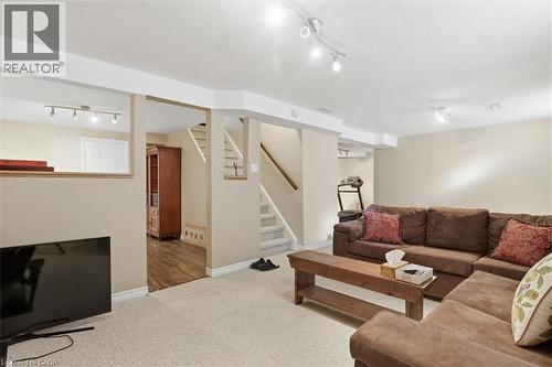 Lower level recreation space featuring neutral carpeting and recessed lighting - 113 Glenecho Court, Waterloo, ON - Indoor
