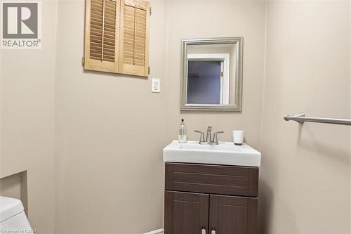 Compact vanity with white rectangular sink, brushed nickel faucet, and espresso-finish cabinetry - 113 Glenecho Court, Waterloo, ON - Indoor Photo Showing Bathroom