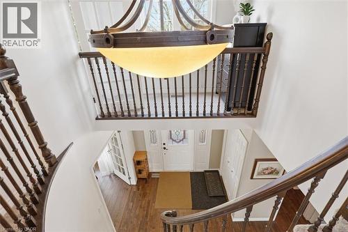 Two-story entry foyer featuring a grand chandelier and wood-finish flooring - 113 Glenecho Court, Waterloo, ON - Indoor Photo Showing Other Room